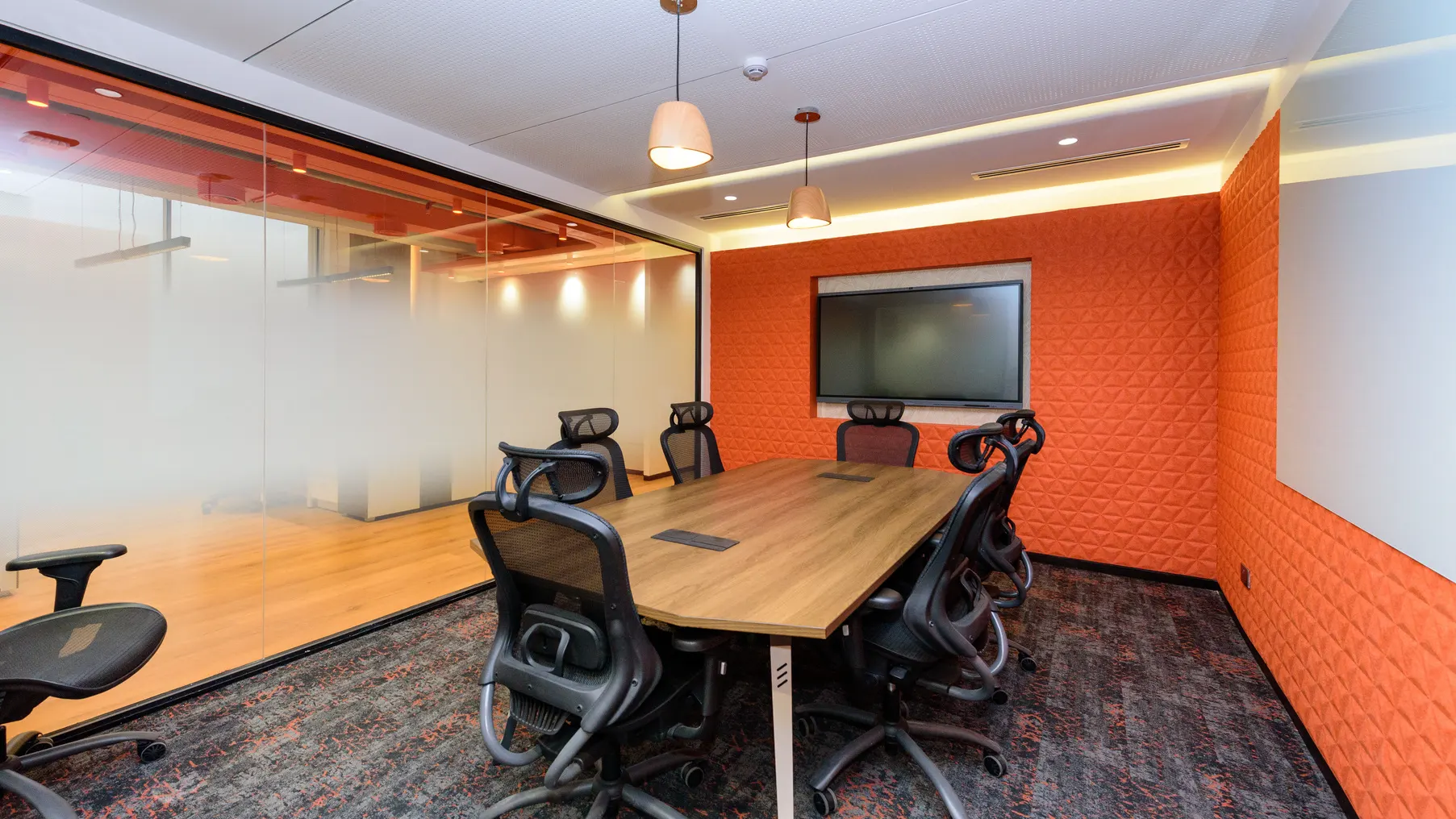 Modern boardroom with acoustic panelling and timber table
